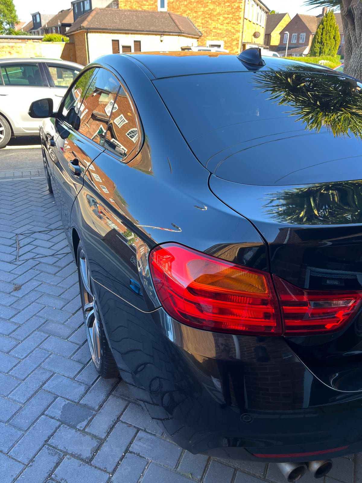 Black BMW 4-series after detailing, paintwork glossy and water spots gone