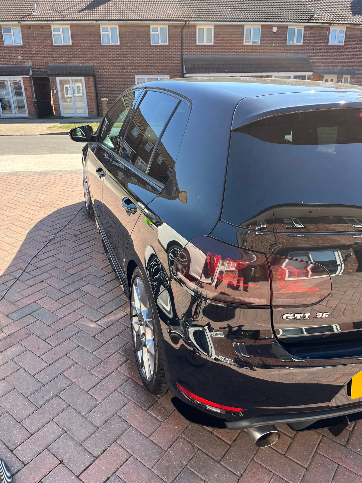 Black VW Golf GTI after detailing, deep wet gloss across the rear panels
