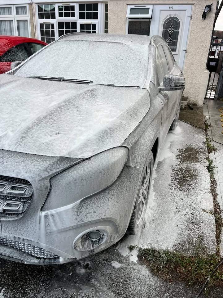 Mercedes GLA under snow foam on a London driveway