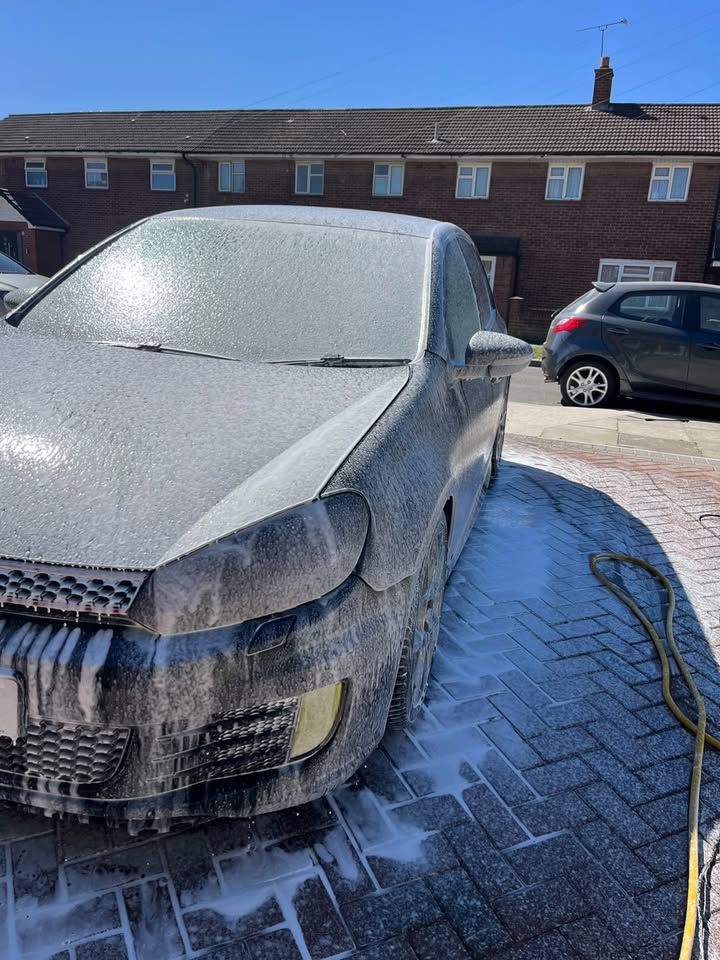 VW Golf GTI being foam washed on a sunny day